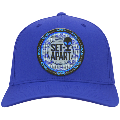 Royal blue cap with a circular design featuring text and an alien figure on a white background.