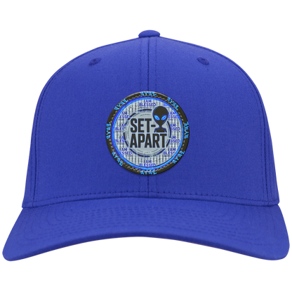 Royal blue cap with a small circular design featuring text and an alien figure on a white background.