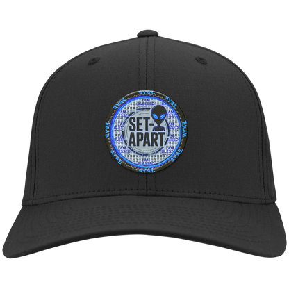Royal blue cap with a small circular design featuring text and an alien figure on a white background.