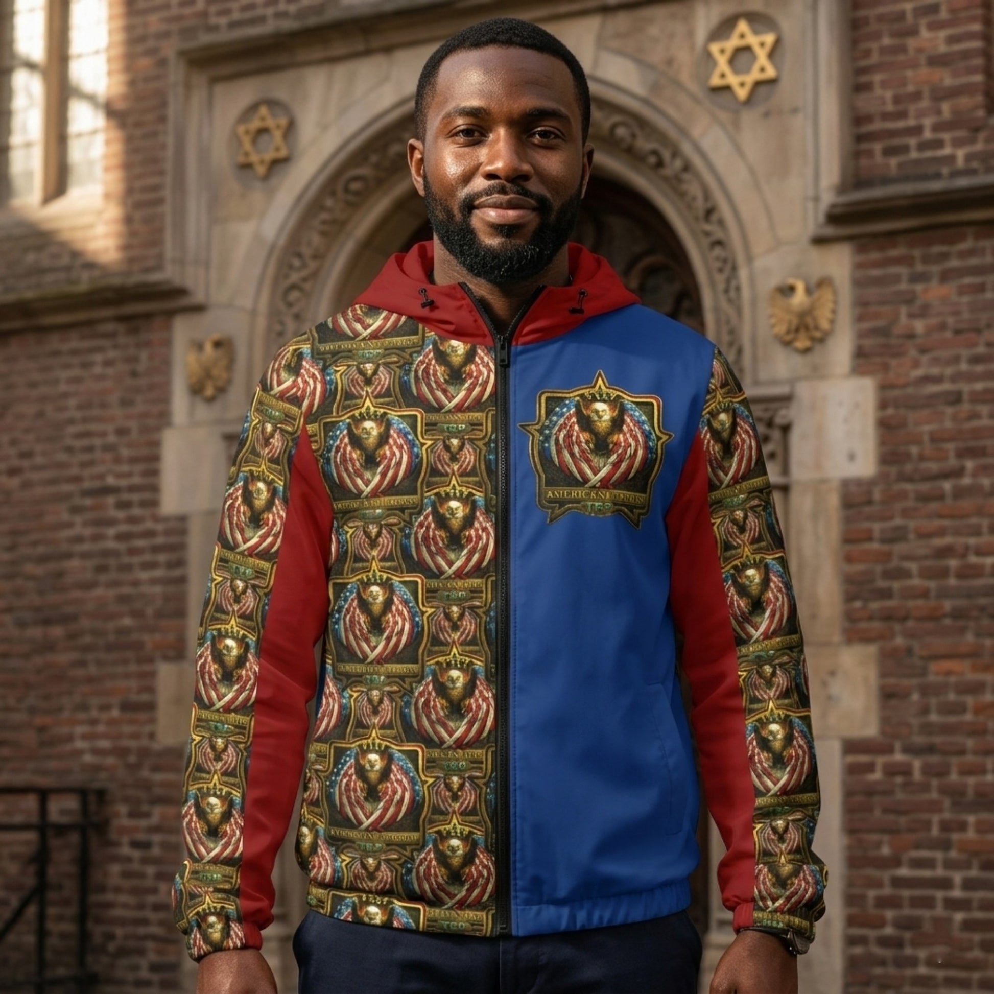 Front view of a man in a red, blue, and patterned windbreaker with eagle emblems, standing before a brick building with a Star of David.
