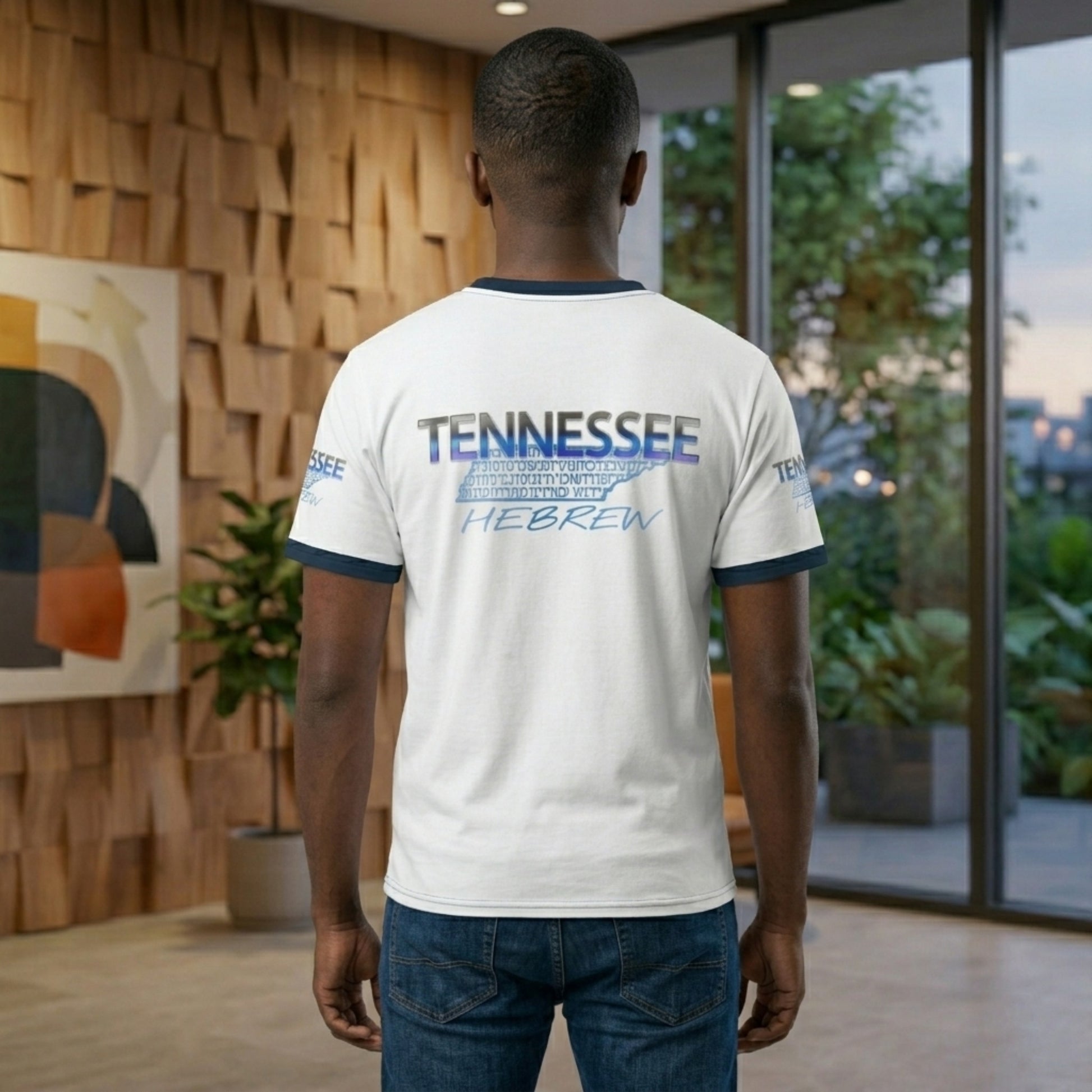 Rear view of the man in the white ringer tee, showing the same "Tennessee Hebrew" graphic centered on the back and printed on the sleeves.