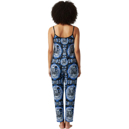 Back view of a person wearing a blue and black patterned sleeveless jumpsuit with spaghetti straps featuring circular "SET APART" alien head graphics.