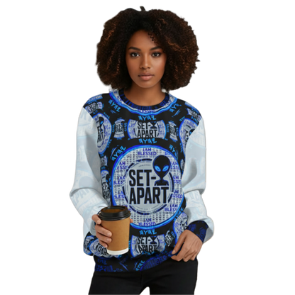 Portrait of a woman with curly hair wearing a "SET-APART" alien pattern sweatshirt and holding coffee.