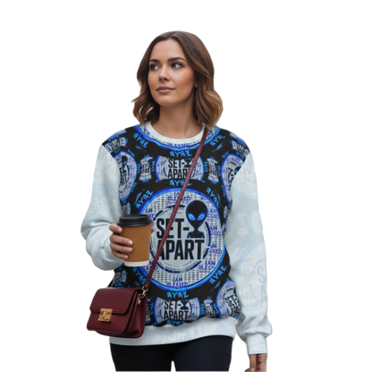 Woman in a sweatshirt with a bold blue and black "SET-APART" alien design, holding coffee.